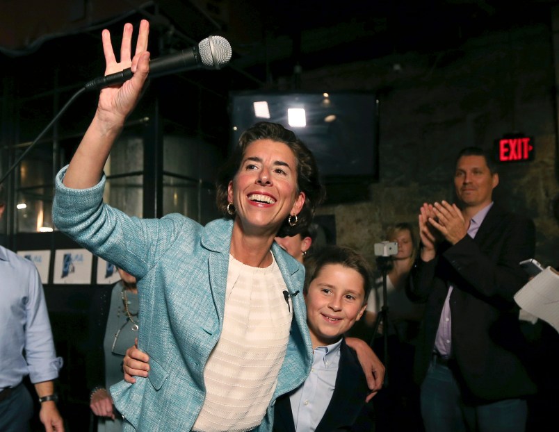 Incumbent Democratic Rhode Island Gov. Gina Raimondo waves to supporters, alongside her son, Thompson, at her primary night victory party, Wednesday, Sept. 12, 2018, in Providence, R.I. (AP Photo/Elise Amendola)