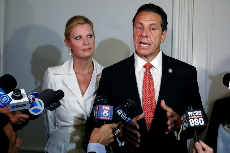 New York Gov. Andrew Cuomo is accompanied by his girlfriend Sandra Lee as he talks to the press after casting his primary election ballot, at the Presbyterian Church of Mount Kisco, in Mt. Kisco, NY, Thursday, Sept. 13, 2018. (AP Photo/Richard Drew)