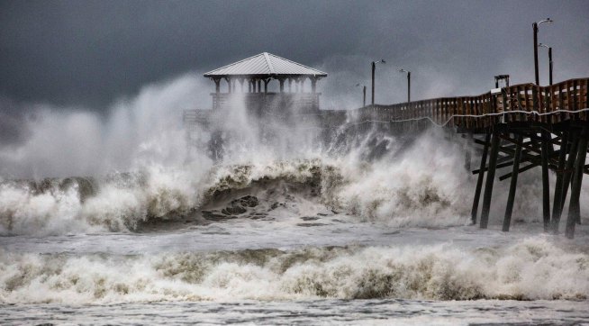 Waves slam the Oceana Pier & Pier House Restaurant in Atlantic Beach, N.C.,  Thursday, Sept. 13, 2018 as Hurricane Florence approaches the area. (Travis Long /The News & Observer via AP)