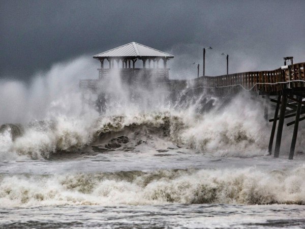 Waves slam the Oceana Pier & Pier House Restaurant in Atlantic Beach, N.C.,  Thursday, Sept. 13, 2018 as Hurricane Florence approaches the area. (Travis Long /The News & Observer via AP)
