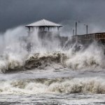 Waves slam the Oceana Pier & Pier House Restaurant in Atlantic Beach, N.C.,  Thursday, Sept. 13, 2018 as Hurricane Florence approaches the area. (Travis Long /The News & Observer via AP)