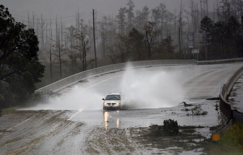 A car drives through water on U.S. 74/76 in Leland, N.C., Saturday, September 15, 2018. The rain from Hurricane Florence was expected to continue through Sunday.         [Matt Born/StarNews Photo]