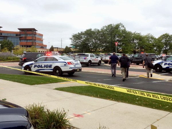 Emergency personnel arrive a the scene where a shooting was reported at a software company in Middleton, Wis., a suburb of Madison, Wednesday, Sept. 19, 2018. Multiple people were reported to have been shot. (AP Photo/Todd Richmond)