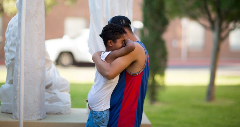 EL PASO, TX July 20: Ariel Romero and his son Jose Romero, 7, of Honduras cry outside of the Loretto-Nazareth Migrant Shelter in El Paso, Texas on July 20, 2018. (Photo by Ivan Pierre Aguirre/ For The Washington Post)