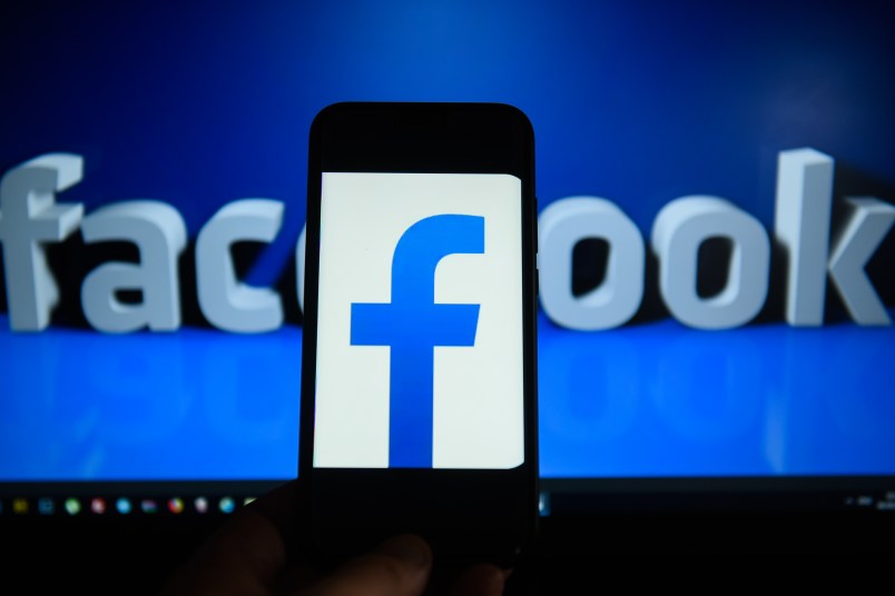 KRAKOW, POLAND - 2018/09/06: Facebook  logo is seen on an android mobile phone in front of a computer screen  with facebook sign. (Photo by Omar Marques/SOPA Images/LightRocket via Getty Images)