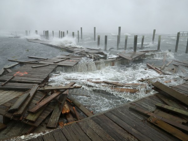Waves crash around the Oceana Pier as the outer edges of Hurricane Florence being to affect the coast September 13, 2018 in Atlantic Beach, United States. Coastal cities in North Carolina, South Carolina and Virgnia are under evacuation orders as the Category 2 hurricane approaches the United States.