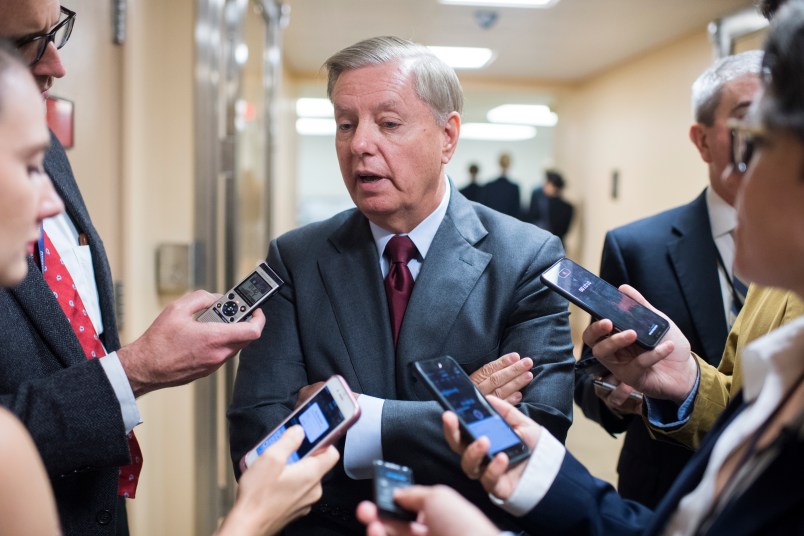 UNITED STATES - SEPTEMBER 25: Sen. Lindsey Graham, R-S.C., talks with reporters in the basement of the Capitol before the Senate policy luncheons on September 25, 2018. (Photo By Tom Williams/CQ Roll Call)