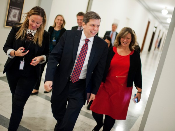 UNITED STATES - DECEMBER 11: Sen. Mark Begich, R-Alaska, and his staff make their way through Russell Building in en route to the Capitol to give his farewell speech on the Senate floor, December 11, 2014. Begich was defeated by sen.-elect Dan Sullivan, R-Alaska. (Photo By Tom Williams/CQ Roll Call)