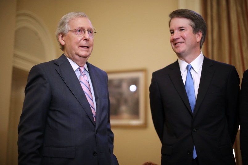 Judge Brett Kavanaugh poses for photographs with Vice President Mike Pence and Senate Majority Leader Mitch McConnell (R-KY) before a meeting in McConnell's office in the U.S. Capitol July 10, 2018 in Washington, DC. U.S. President Donald Trump nominated Kavanaugh to succeed retiring Supreme Court Associate Justice Anthony Kennedy.