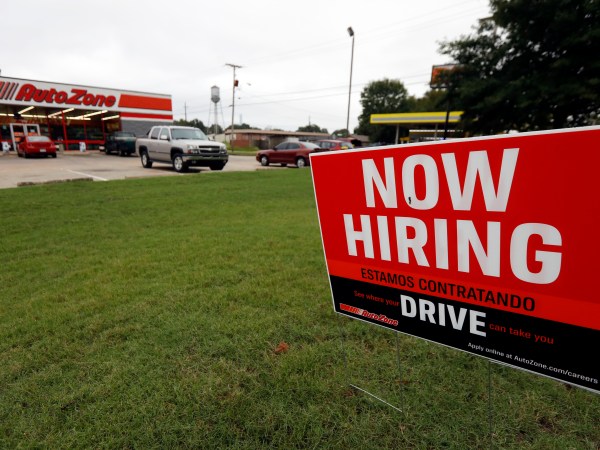 A bilingual help wanted sign for Auto Zone, a retailer of aftermarket automotive parts and accessories, is posted outside the store in Canton, Miss., Thursday, Sept. 27, 2018. The central Mississippi city has a growing Spanish-speaking population and some merchants are actively recruiting bilingual counter help. (AP Photo/Rogelio V. Solis)