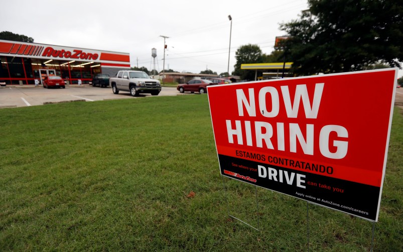 A bilingual help wanted sign for Auto Zone, a retailer of aftermarket automotive parts and accessories, is posted outside the store in Canton, Miss., Thursday, Sept. 27, 2018. The central Mississippi city has a growing Spanish-speaking population and some merchants are actively recruiting bilingual counter help. (AP Photo/Rogelio V. Solis)