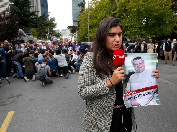 A journalist holding a poster with a photo of the missing Saudi writer Jamal Khashoggi, makes a piece on camera while covering a protest in his support near the Saudi Arabia consulate in Istanbul, Monday, Oct. 8, 2018.Turkish officials have said they believe that the journalist was slain in "a preplanned murder" at the kingdom's consulate and that his body was later removed. Saudi officials have denied the allegations as baseless.(AP Photo/Lefteris Pitarakis)
