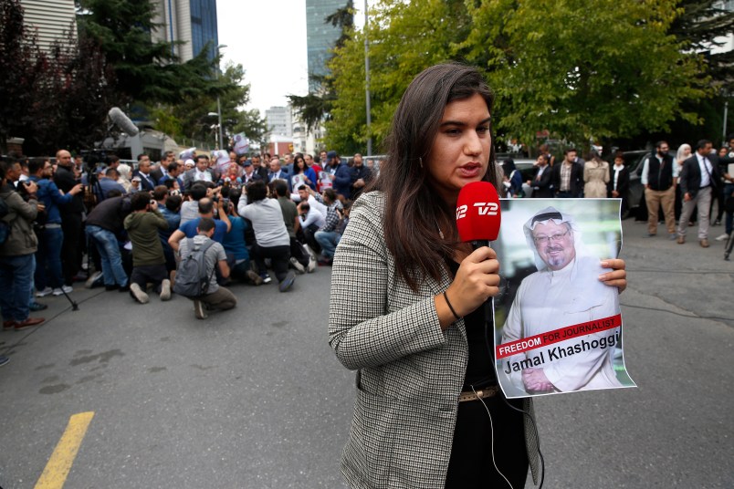 A journalist holding a poster with a photo of the missing Saudi writer Jamal Khashoggi, makes a piece on camera while covering a protest in his support near the Saudi Arabia consulate in Istanbul, Monday, Oct. 8, 2018.Turkish officials have said they believe that the journalist was slain in "a preplanned murder" at the kingdom's consulate and that his body was later removed. Saudi officials have denied the allegations as baseless.(AP Photo/Lefteris Pitarakis)