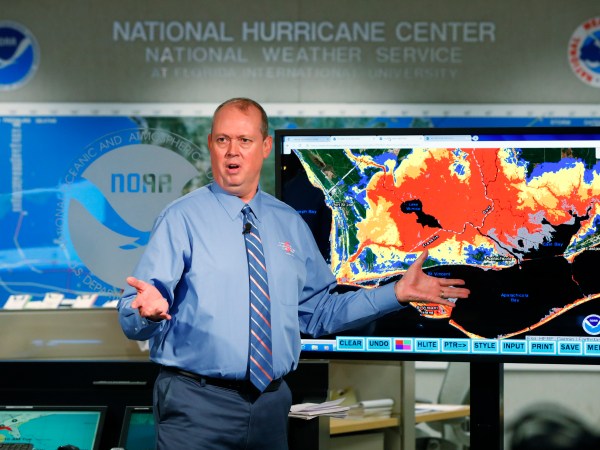 National Hurricane Center director Ken Graham, gestures as he talks about storm surge during a televised update on the status of Hurricane Michael, Tuesday, Oct. 9, 2018, at the Hurricane Center in Miami. At least 120,000 people along the Florida Panhandle were ordered to clear out Tuesday as Hurricane Michael rapidly picked up steam in the Gulf of Mexico and closed in with winds of 110 mph (175 kph) and a potential storm surge of 12 feet (3.7 meters). (AP Photo/Wilfredo Lee)