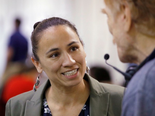 HOLD FOR STORY - FILE - In this Oct. 1, 2018, file photo, Democratic Congressional candidate Sharice Davids talks to volunteer at her campaign office in Overland Park, Kan. Davids is challenging Republican incumbent Kevin Yoder in Kansas' 3rd District. (AP Photo/Charlie Riedel, File)