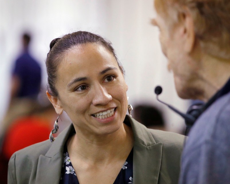 HOLD FOR STORY - FILE - In this Oct. 1, 2018, file photo, Democratic Congressional candidate Sharice Davids talks to volunteer at her campaign office in Overland Park, Kan. Davids is challenging Republican incumbent Kevin Yoder in Kansas' 3rd District. (AP Photo/Charlie Riedel, File)