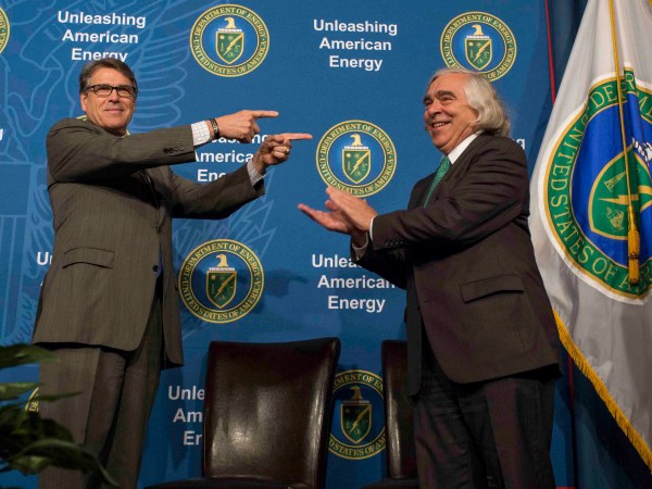 In this Aug. 2, 2018 photo made available by the U.S. Department of Energy, Energy Secretary Rick Perry welcoming his predecessor, Ernest Moniz, during the unveiling of Moniz's portrait. Simon Edelman/U.S. Department of Energy     https://www.flickr.com/photos/departmentofenergy/36202965571/in/photolist-ny1wad-XigXwL-XigXHs-Xa8EU6-N7N3cM-Xa8F2v-XigXA3-Xa8EJX-Xa8EEZ-Xa8F7F-Xa8ETe-X7i1W1-Xa8F3H-bF5Abh-vE7kH9-KZnGYL-X5pZHf-224K5Jp-DVPeYm-224K5sT-DVPfAU-224K572-fkwAbh-Xa8Enz-CqdLEn-2222eqQ-224KUu4-224Lmr4-CqdM12-CqdN8x