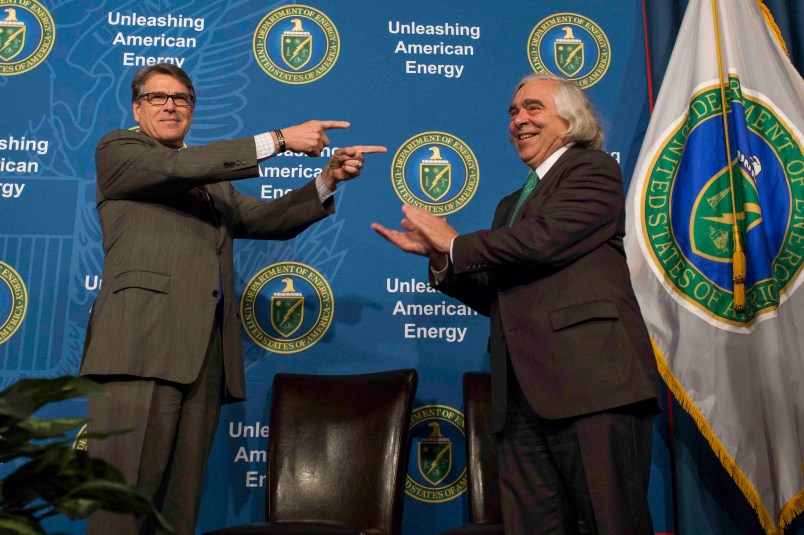 In this Aug. 2, 2018 photo made available by the U.S. Department of Energy, Energy Secretary Rick Perry welcoming his predecessor, Ernest Moniz, during the unveiling of Moniz's portrait. Simon Edelman/U.S. Department of Energy     https://www.flickr.com/photos/departmentofenergy/36202965571/in/photolist-ny1wad-XigXwL-XigXHs-Xa8EU6-N7N3cM-Xa8F2v-XigXA3-Xa8EJX-Xa8EEZ-Xa8F7F-Xa8ETe-X7i1W1-Xa8F3H-bF5Abh-vE7kH9-KZnGYL-X5pZHf-224K5Jp-DVPeYm-224K5sT-DVPfAU-224K572-fkwAbh-Xa8Enz-CqdLEn-2222eqQ-224KUu4-224Lmr4-CqdM12-CqdN8x