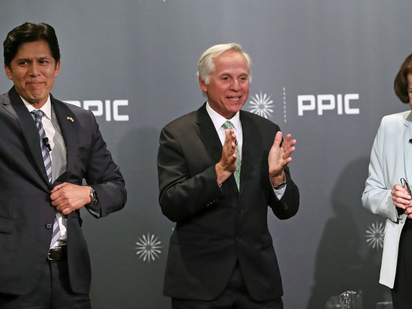 Public Policy Institute of California CEO and debate monitor Mark Baldassare, center, applauds at the end of the debate between California Sen. Kevin de Leon, D-Los Angeles, left, and California Sen. Dianne Feinstein, D-Calif., on Wednesday, Oct. 17, 2018, in San Francisco. Feinstein shared the stage with an opponent for the first time since 2000 when she debated state Sen. Kevin de Leon. The two Democrats are facing off in the Nov. 6 election. (AP Photo/Ben Margot)
