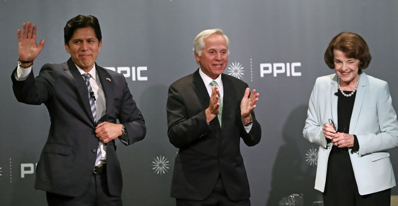 Public Policy Institute of California CEO and debate monitor Mark Baldassare, center, applauds at the end of the debate between California Sen. Kevin de Leon, D-Los Angeles, left, and California Sen. Dianne Feinstein, D-Calif., on Wednesday, Oct. 17, 2018, in San Francisco. Feinstein shared the stage with an opponent for the first time since 2000 when she debated state Sen. Kevin de Leon. The two Democrats are facing off in the Nov. 6 election. (AP Photo/Ben Margot)