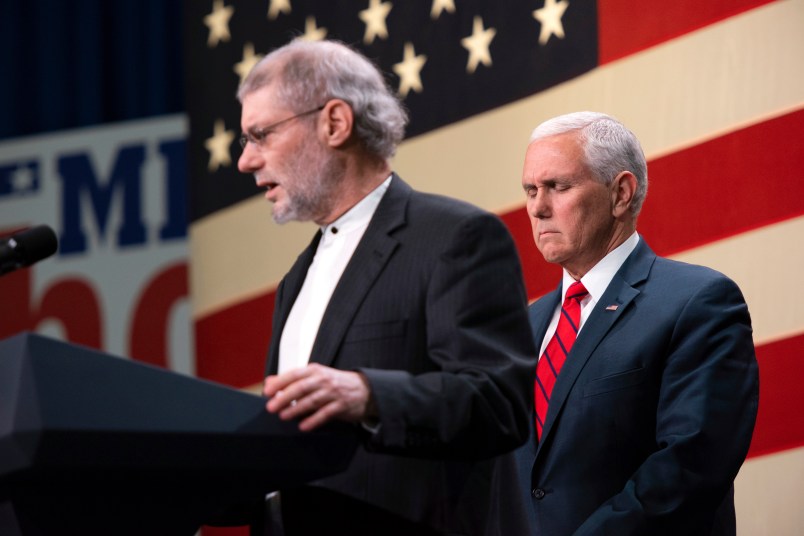 Vice President Mike Pence prays with a Rabbi Loren Jacobs, of Bloomfield Hills' Congregation Shema Yisrael, for the victims and families of those killed in the Pittsburgh synagogue shooting at a rally for Republicans in Oakland County Monday at the Oakland County Airport in Waterford, Oct. 29, 2018. (Tanya Moutzalias | MLive.com) Tanya Moutzalias | MLive.com