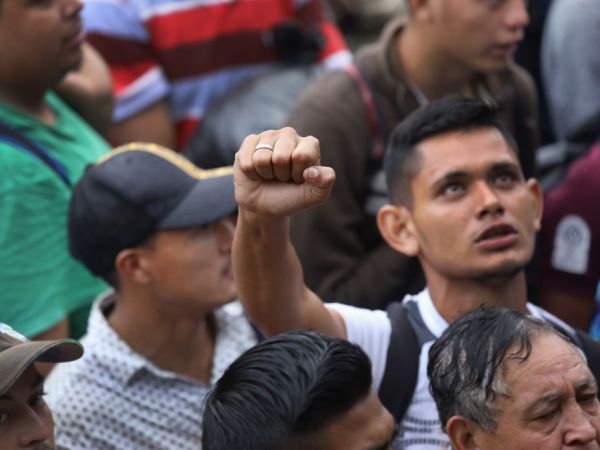 TECUN UMAN, GUATEMALA - OCTOBER 19: Members of a migrant caravan gather before attempting to cross the Guatemalan border into Mexico on October 19, 2018 in Tecun Uman, Guatemala. The caravan of thousands of Central Americans, mostly from Honduras, hopes to eventually reach the United States. U.S. President Donald Trump has threatened to cancel the recent trade deal with Mexico and withhold aid to Central American countries if the caravan isn't stopped before reaching the U.S.  (Photo by John Moore/Getty Images)