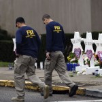 Members of the FBI walk past a memorial outside the Tree of Life synagogue after a shooting there left 11 people dead in the Squirrel Hill neighborhood of Pittsburgh on October 27. - Mourners held an emotional vigil Sunday for victims of a fatal shooting at a Pittsburgh synagogue, an assault that saw a gunman who said he "wanted all Jews to die" open fire on a mostly elderly group. Americans had earlier learned the identities of the 11 people killed in the brutal assault at the Tree of Life synagogue, including 97-year-old Rose Mallinger and couple Sylvan and Bernice Simon, both in their 80s.Nine of the victims were 65 or older. (Photo by Brendan SMIALOWSKI / AFP)        (Photo credit should read BRENDAN SMIALOWSKI/AFP/Getty Images)