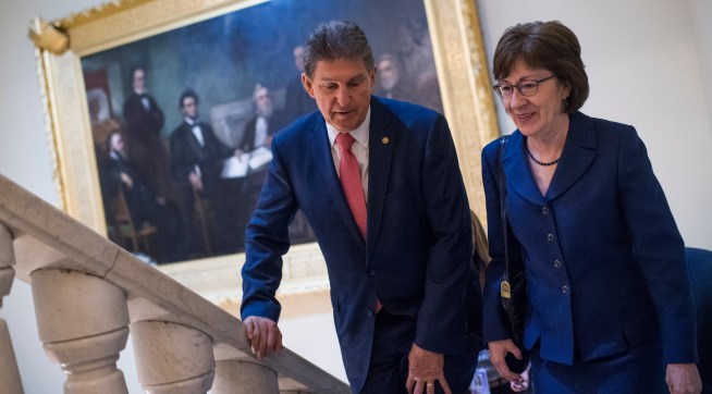 UNITED STATES - JANUARY 22: Sens. Joe Manchin, D-W.Va., and Susan Collins, R-Maine, make their way to a news conference in the Capitol after the Senate passed a continuing resolution to reopen the government on January 22, 2018. (Photo By Tom Williams/CQ Roll Call)
