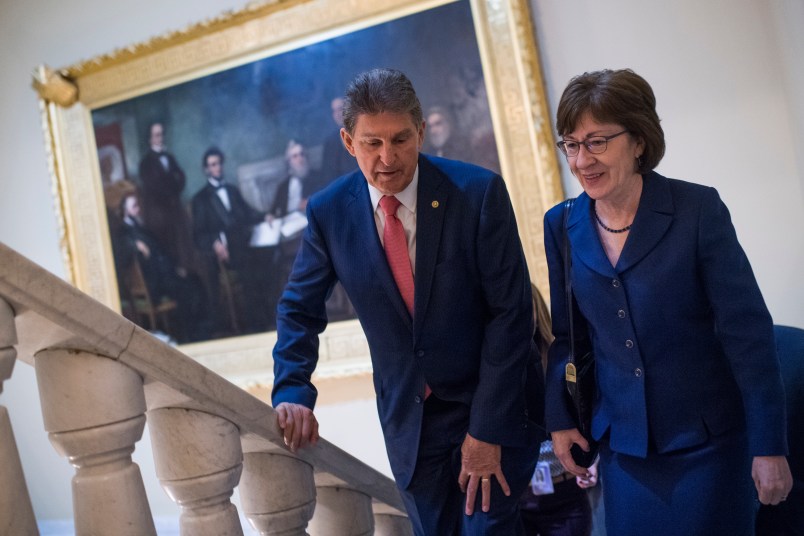 UNITED STATES - JANUARY 22: Sens. Joe Manchin, D-W.Va., and Susan Collins, R-Maine, make their way to a news conference in the Capitol after the Senate passed a continuing resolution to reopen the government on January 22, 2018. (Photo By Tom Williams/CQ Roll Call)