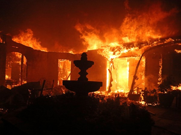 A Spanish-style home is consumed by flames on Dume Drive in the Point Dume area of Malibu, Calif., Friday, Nov. 9, 2018. Known as the Woolsey fire, it has consumed thousands of acres and destroyed multiple homes. (AP Photo/Reed Saxon)