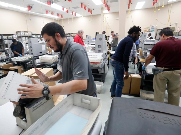 Employees at the Broward County Supervisor of Elections office recount ballots, Wednesday, Nov. 14, 2018, in Lauderhill, Fla. (AP Photo/Wilfredo Lee)