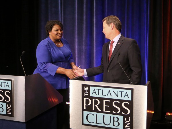 Democrat candidate for Georgia Governor Stacey Abrams and Republican Secretary of State Brian Kemp greet each other before a debate Tuesday, Oct. 23, 2018, in Atlanta. (AP Photo/John Bazemore)