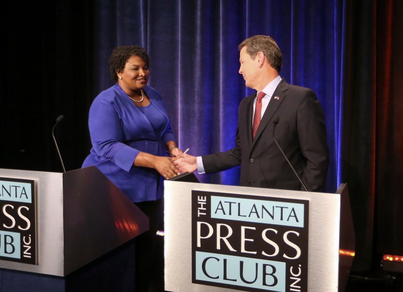 Democrat candidate for Georgia Governor Stacey Abrams and Republican Secretary of State Brian Kemp greet each other before a debate Tuesday, Oct. 23, 2018, in Atlanta. (AP Photo/John Bazemore)