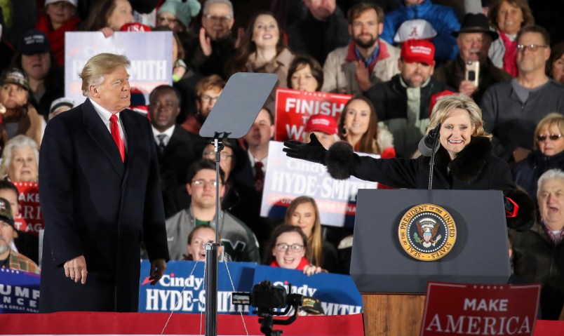 TUPELO, MS - NOVEMBER 26: (L-R) President Donald Trump looks on as Republican candidate for U.S. Senate Cindy Hyde-Smith thanks him during a rally at the Tupelo Regional Airport, November 26, 2018 in Tupelo, Mississippi. President Trump is holding two rallies on Monday in Mississippi, in support of Republican candidate for U.S. Senate Cindy Hyde-Smith. Hyde-Smith faces off against Democratic candidate Mike Espy in a runoff election on Tuesday. (Photo by Drew Angerer/Getty Images)