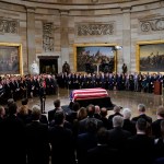 The flag-draped casket of former President George H.W. Bush lies in state in the Capitol Rotunda in Washington, Monday, Dec. 3, 2018. (AP Photo/Pablo Martinez Monsivais/Pool)