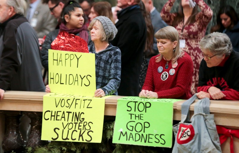 Protesters Peppi Elder, left, and Christine Taylor during the lighting of the 2018 State Capitol Christmas Tree in the Wisconsin State Capitol Rotunda. The Senate and Assembly are set to send dozens of changes in state law to Gov. Scott Walker’s desk Tuesday Dec. 4, 2018 at the Capitol in Madison. (AP Photo/Wisconsin State Journal, Steve Apps)