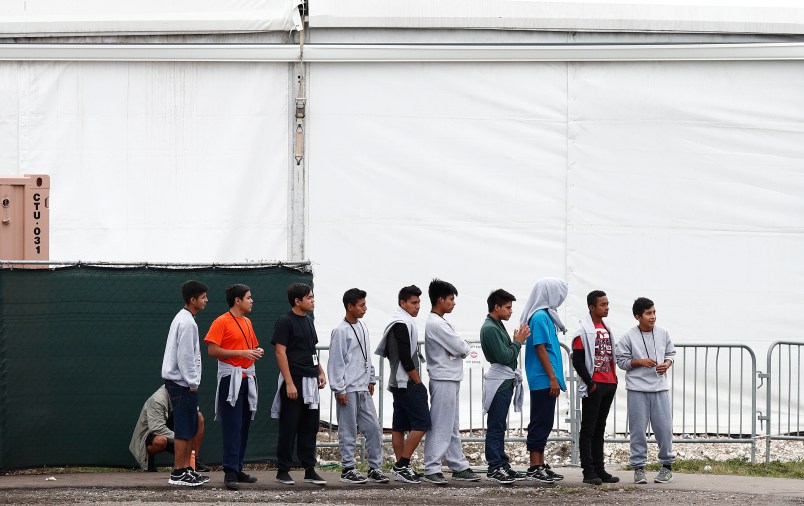 Immigrant boys walk in a line at the Homestead Temporary Shelter for Unaccompanied Children a former Job Corps site that now houses them Monday, Dec. 10, 2018, in Homestead, Fla. (AP Photo/Brynn Anderson)