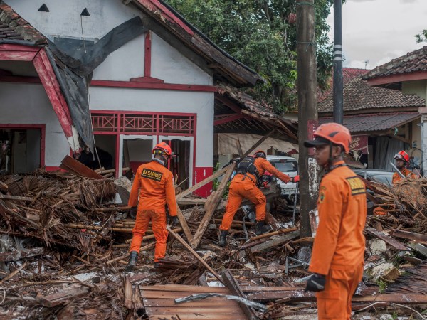 Rescuers search for tsunami victims in Carita, Indonesia, Sunday, Dec. 23, 2018. The tsunami that killed dozens of people around Indonesia's Sunda Strait during a busy holiday weekend, sending water crashing ashore and sweeping away hotels, hundreds of houses and people attending a beach concert. (AP Photo/Fauzy Chaniago)