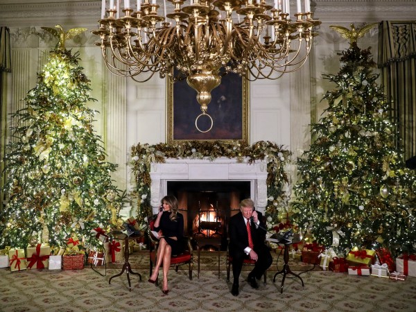 WASHINGTON, DC - DECEMBER 24: President Donald Trump and first lady Melania Trump speak on the phone with children as they track Santa Claus with the North American Aerospace Defense Command, NORAD, on Christmas Eve in the State Dinning Room of the White House on December 24, 2018 in Washington, DC.(Photo by Oliver Contreras/For The Washington Post)