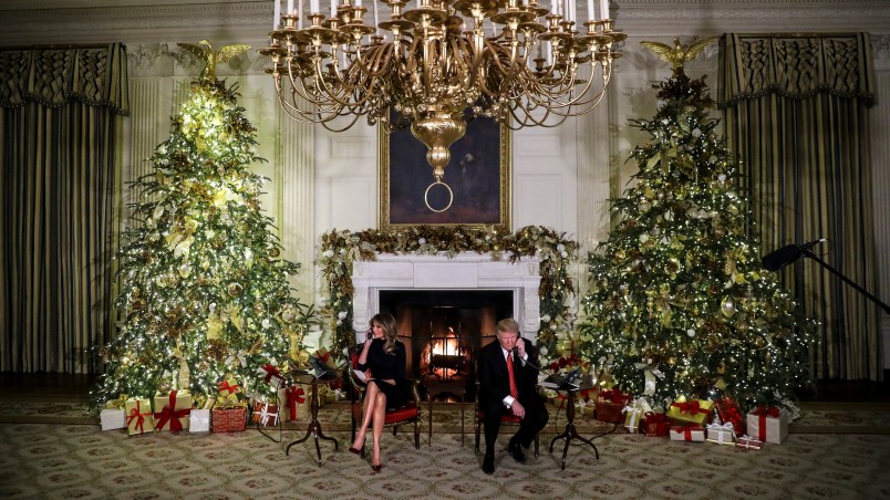 WASHINGTON, DC - DECEMBER 24: President Donald Trump and first lady Melania Trump speak on the phone with children as they track Santa Claus with the North American Aerospace Defense Command, NORAD, on Christmas Eve in the State Dinning Room of the White House on December 24, 2018 in Washington, DC.(Photo by Oliver Contreras/For The Washington Post)