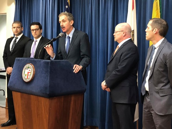 Los Angeles City Attorney Mike Feuer, at podium, speaks at a news conference in Los Angeles Friday, Jan. 4, 2019. Feuer said that owners of The Weather Channel app, one of the most popular mobile weather apps, used it to track people's every step and profit off that information. Feuer said the company misled users of the popular app to think their location data will only be used for personalized forecasts and alerts. A spokesman for app owner IBM Corp. says it's been clear about the use of location data and will vigorously defend its "fully appropriate" disclosures. (AP Photo/Brian Melley)
