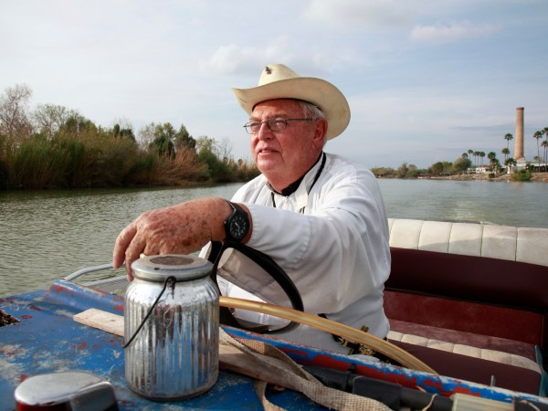 In this Tuesday, January 8, 2019 photo, father Roy Snipes, pastor of the La Lomita Chapel, shows Associated Press journalists the land on either side of the Rio Grande at the US-Mexico border on Tuesday January 8, 2019 in Mission, Texas. Portions of Father Snipes' church land in Mission could be seized by the federal government to construct additional border wall and fence lines. Rather than surrender their land to the federal government, some property owners on the Texas border are digging in to fight President Donald Trump's border wall. They are rejecting buyout offers and preparing to battle the administration in court. Trump is scheduled to travel to the border Thursday to make the case for his $5.7 billion wall. (AP Photo/John L. Mone)