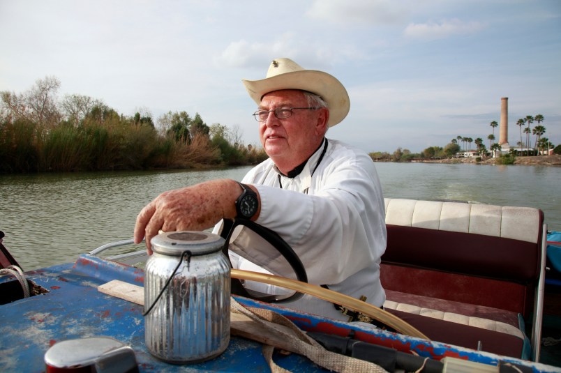 In this Tuesday, January 8, 2019 photo, father Roy Snipes, pastor of the La Lomita Chapel, shows Associated Press journalists the land on either side of the Rio Grande at the US-Mexico border on Tuesday January 8, 2019 in Mission, Texas. Portions of Father Snipes' church land in Mission could be seized by the federal government to construct additional border wall and fence lines. Rather than surrender their land to the federal government, some property owners on the Texas border are digging in to fight President Donald Trump's border wall. They are rejecting buyout offers and preparing to battle the administration in court. Trump is scheduled to travel to the border Thursday to make the case for his $5.7 billion wall. (AP Photo/John L. Mone)