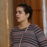 Rahaf Mohammed Alqunun holds a mobile phone in Bangkok, Thailand, Friday, Jan. 11, 2019.  Alqunun, the 18-year old Saudi woman who fled her family to seek asylum, remains in Thailand under the care of the U.N. refugee agency as she awaits a decision by a third country to accept her as a refugee. (AP Photo/Sakchai Lalit)