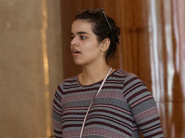 Rahaf Mohammed Alqunun holds a mobile phone in Bangkok, Thailand, Friday, Jan. 11, 2019.  Alqunun, the 18-year old Saudi woman who fled her family to seek asylum, remains in Thailand under the care of the U.N. refugee agency as she awaits a decision by a third country to accept her as a refugee. (AP Photo/Sakchai Lalit)