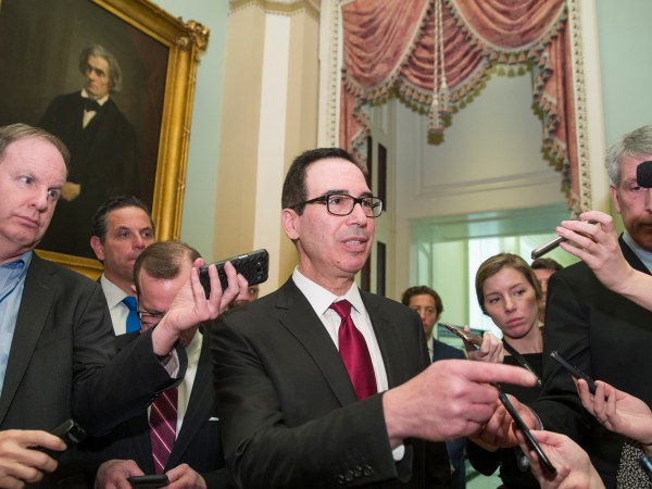 Treasury Secretary Steve Mnuchin, center, speaks with reporters as he departs the Republican policy luncheon on Capitol Hill, Tuesday, Jan. 15, 2019 in Washington. (AP Photo/Alex Brandon)