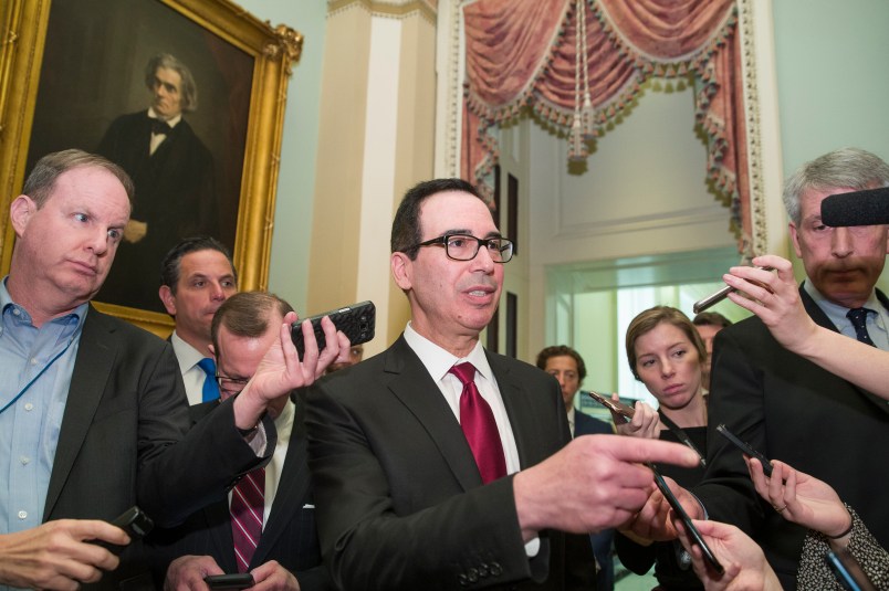 Treasury Secretary Steve Mnuchin, center, speaks with reporters as he departs the Republican policy luncheon on Capitol Hill, Tuesday, Jan. 15, 2019 in Washington. (AP Photo/Alex Brandon)