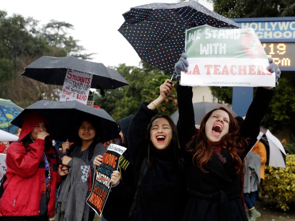 Maria Arienza, right, an English and Spanish teacher, shouts slogans alongside her student Stephanie Medrano, second from right, outside of North Hollywood High School Tuesday, Jan. 15, 2019, in Los Angeles. Teachers in the huge Los Angeles Unified School District walked picket lines again Tuesday as administrators urged them to return to classrooms and for their union to return to the bargaining table. (AP Photo/Marcio Jose Sanchez)