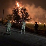 In this image provided by the Secretary of National Defense, soldiers guard the area where the explosion was recorded in Tlahuelilpan, Hidalgo state, Mexico, Friday, Jan. 18, 2019. A huge fire exploded at a pipeline leaking fuel in central Mexico on Friday, killing at least 21 people and badly burning 71 others as locals were collecting the spilling gasoline in buckets and garbage cans, officials said.The leak was caused by an illegal tap that fuel thieves had drilled into the pipeline in a small town in the state of Hidalgo, about 62 miles (100 kilometers) north of Mexico City, according to state oil company Petroleos Mexicanos, or Pemex. (Secretary of National Defense via AP)