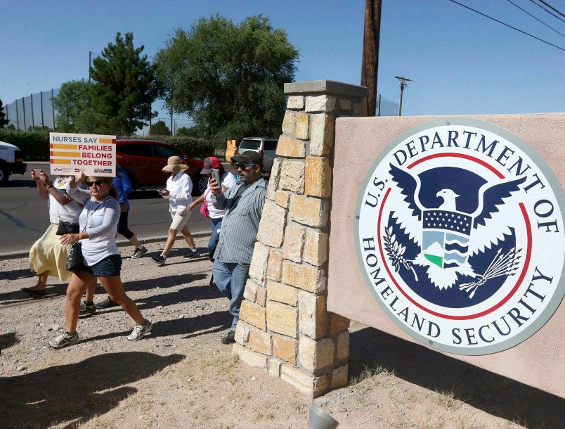 File-This June 2018, file photo shows protesters walking along Montana Avenue outside the El Paso Processing Center, in El Paso, Texas. Federal immigration officials are force feeding some of the dozens of Cuban and Indian immigrants who have been on hunger strike for nearly a month inside a Texas detention facility, The Associated Press has learned.  (Rudy Gutierrez/The El Paso Times via AP, File)